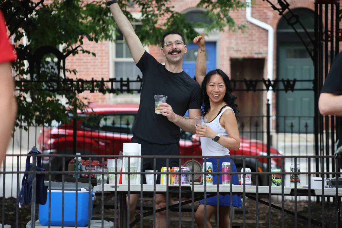 Volunteers raising a toast at the Yappy Hour drinks table