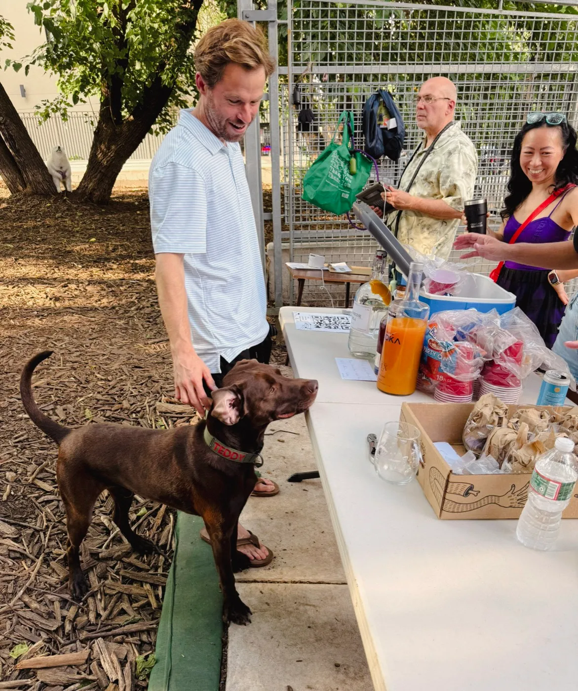 A neighbor and his dog at the Yappy Hour table