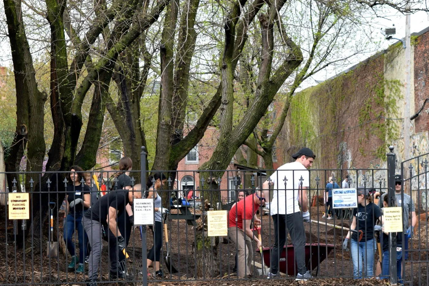 Volunteers at a park workday along the fence